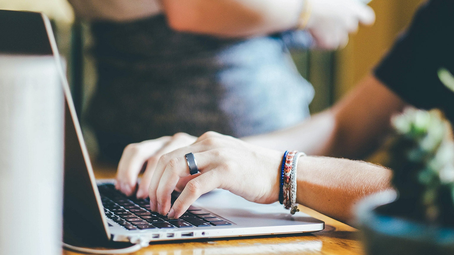 A close view of a designer working on a laptop