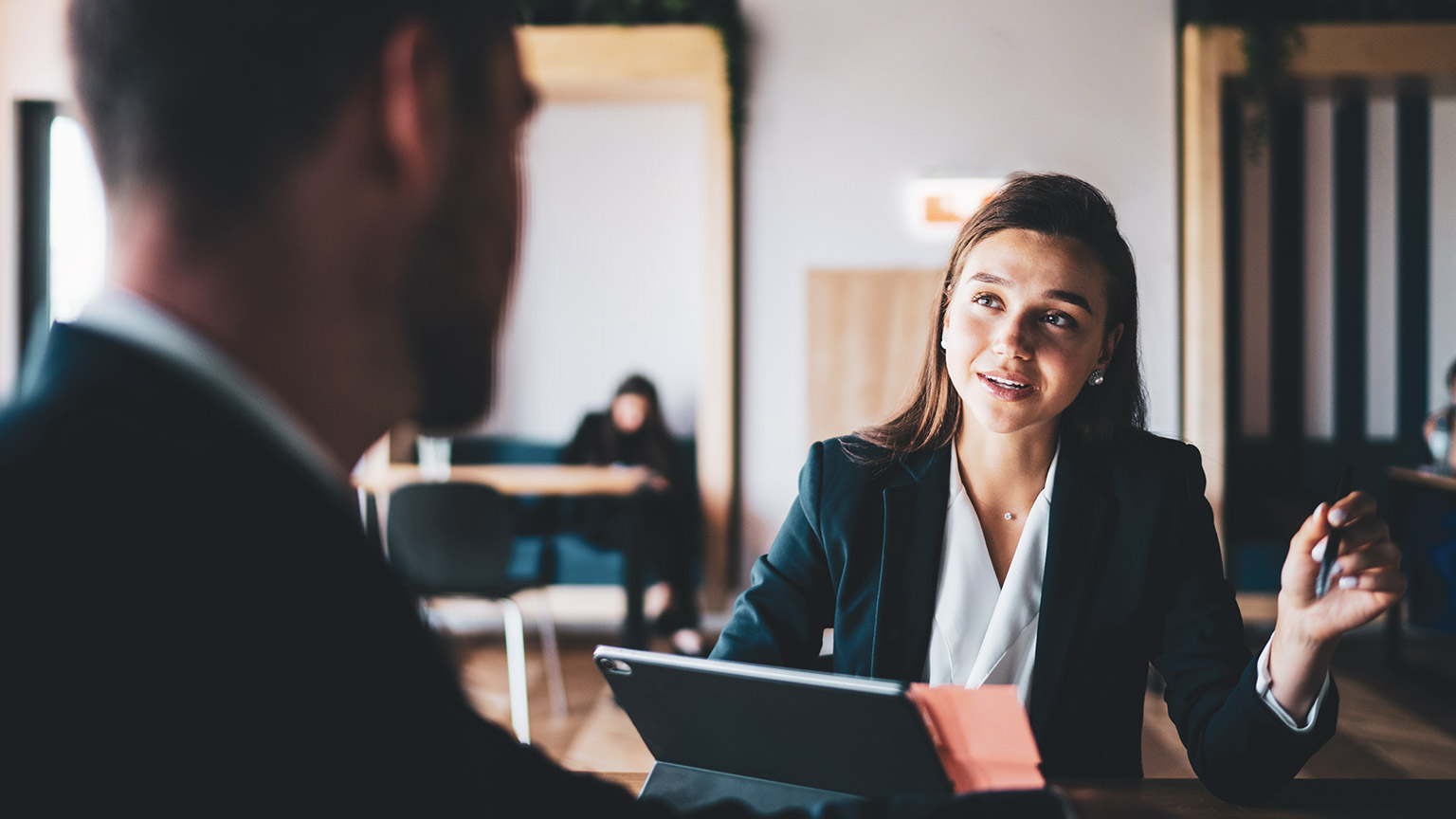 A business manager discussing a work issue with a colleague