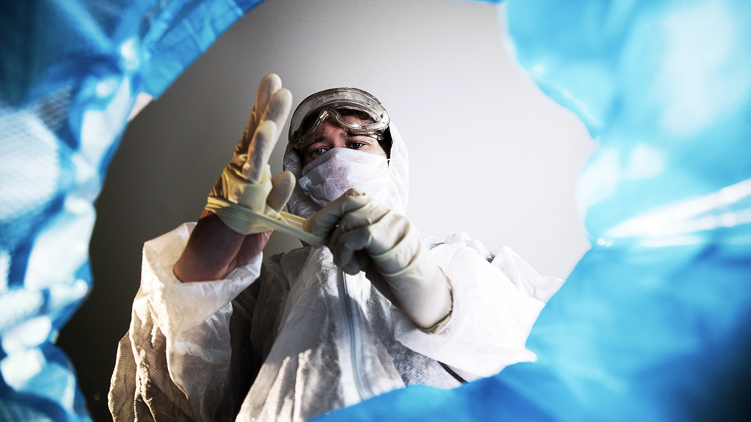 A carer disposing gloves in a medical waste bag