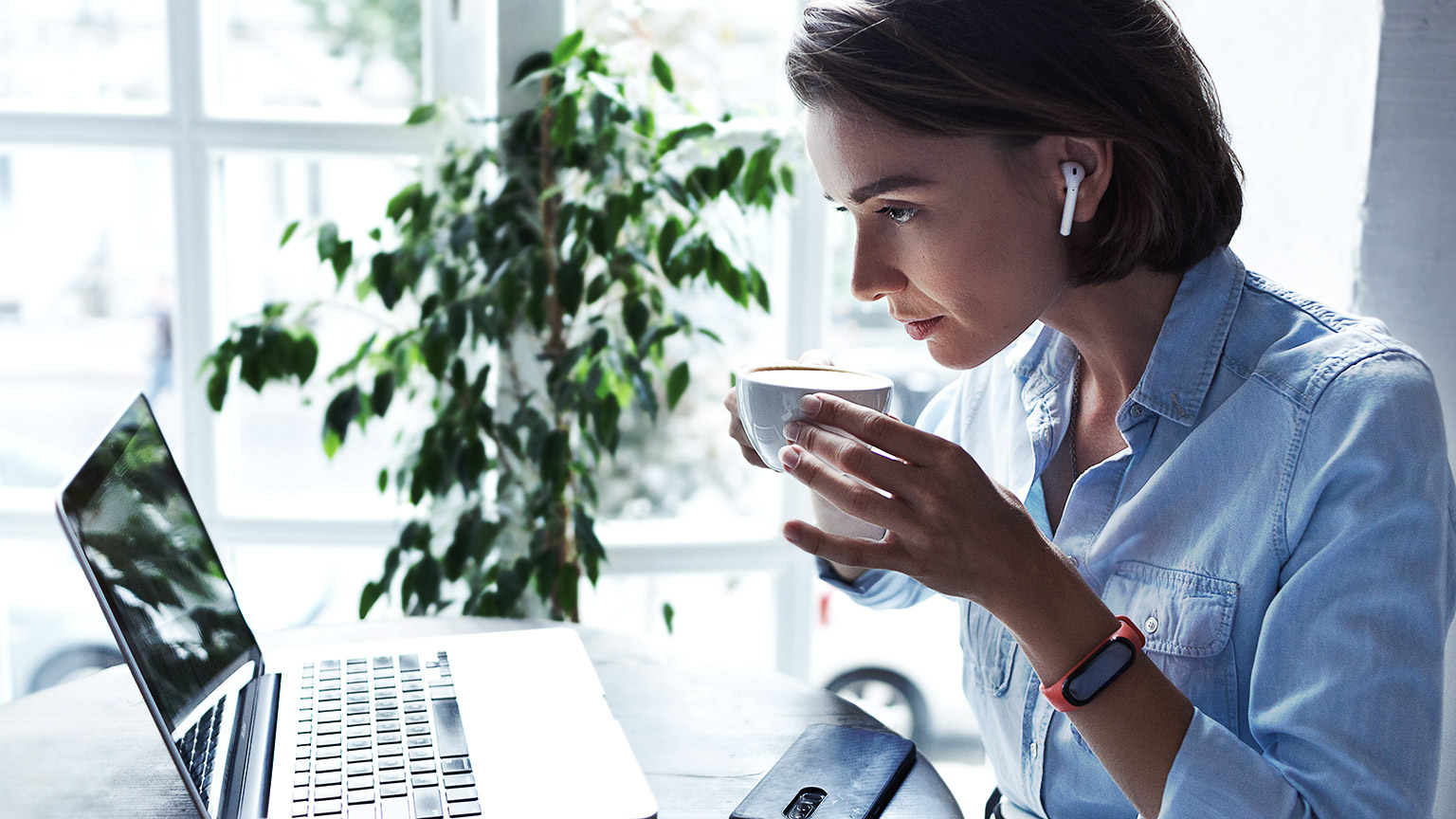 An aspiring bookkeeper reading compliance and support materials on a laptop