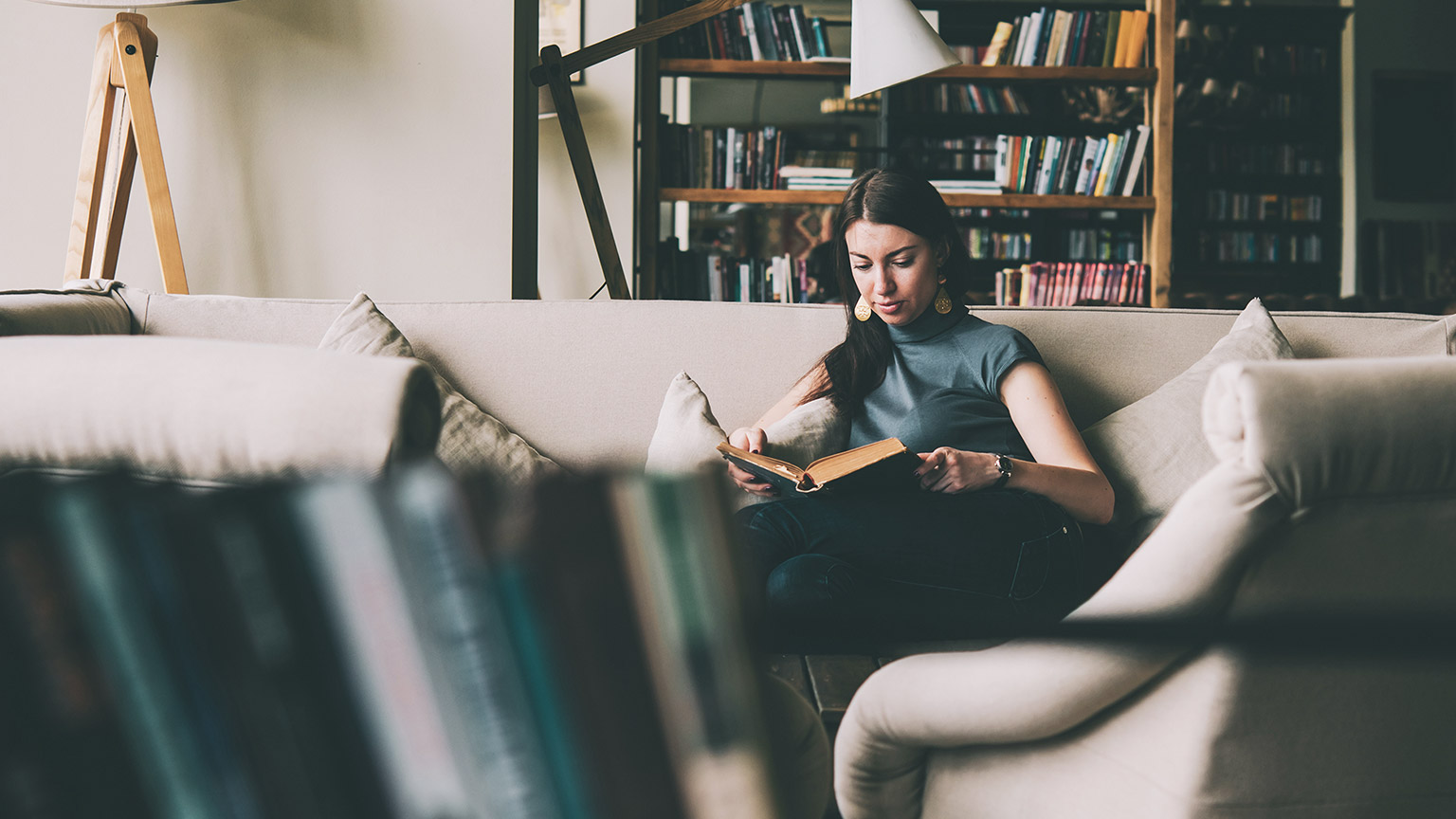 A young designer reading reference material in a relaxed environment