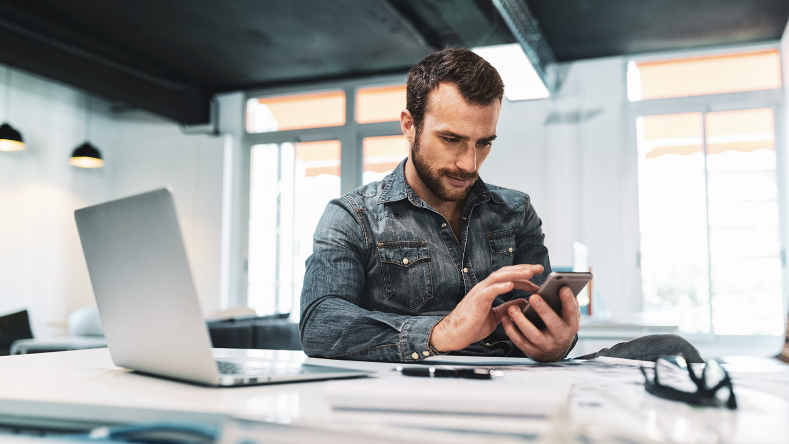 A manager accessing business information on a mobile phone