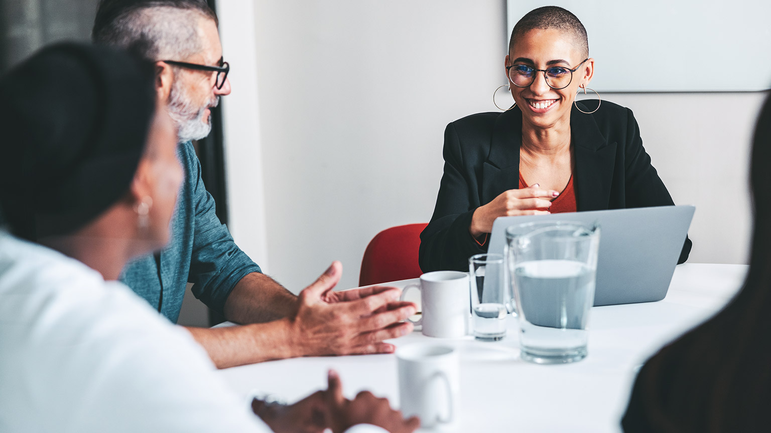 A business leader engaging with colleagues in a meeting