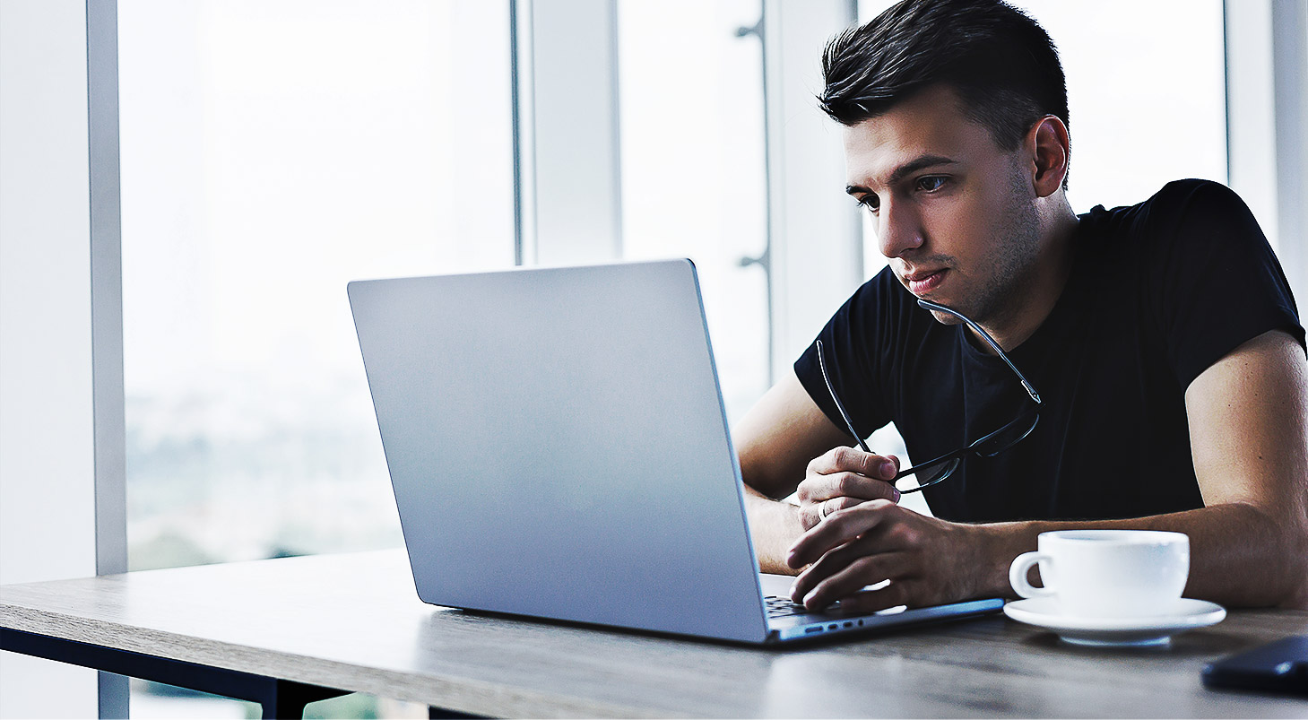 A person reading on a laptop