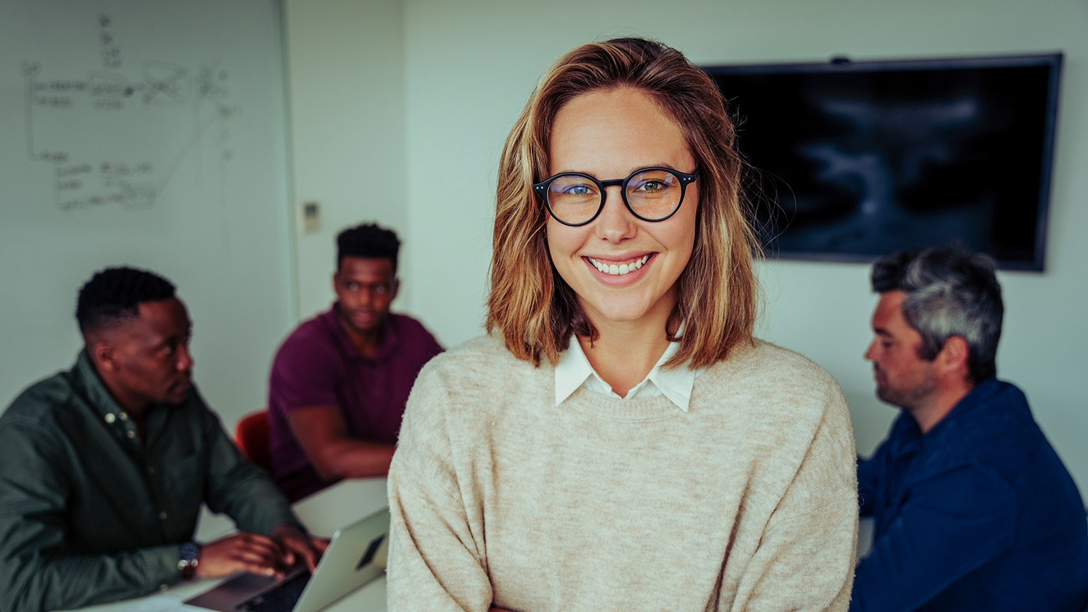 A young professional in a meeting with several colleagues