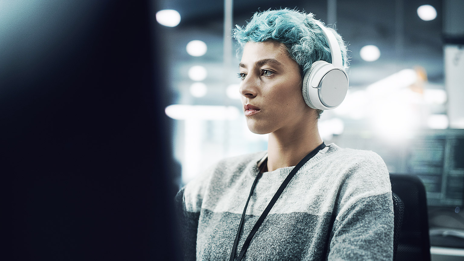 A person listening to a webinar or meeting through a headset