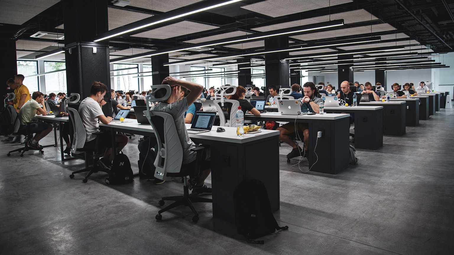 A wide shot of a modern office space with multiple employees working