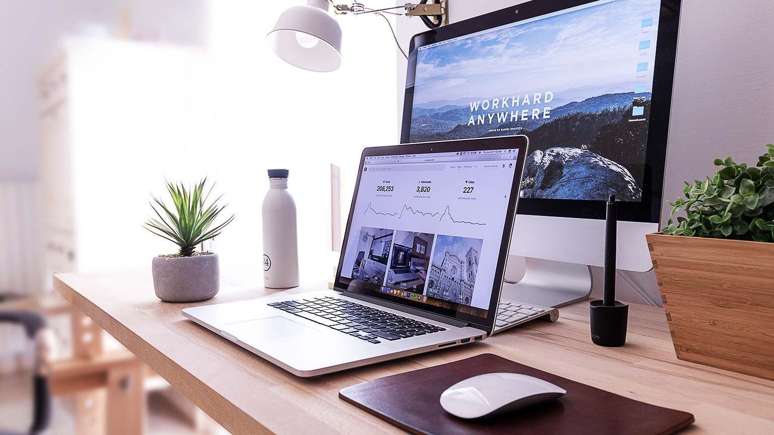 A laptop and a desktop computer on a desk