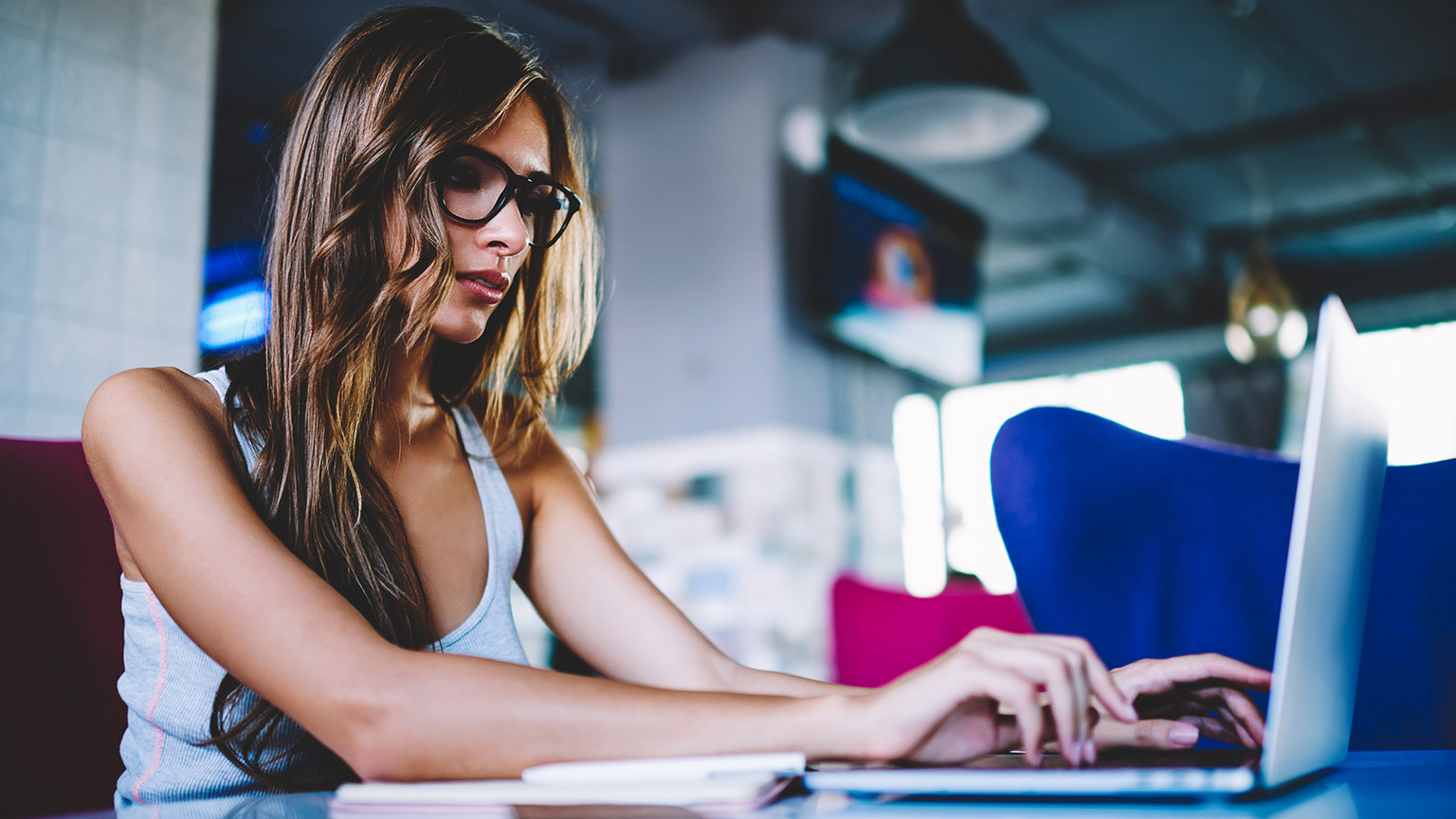 A designer researching work opportunities on a laptop