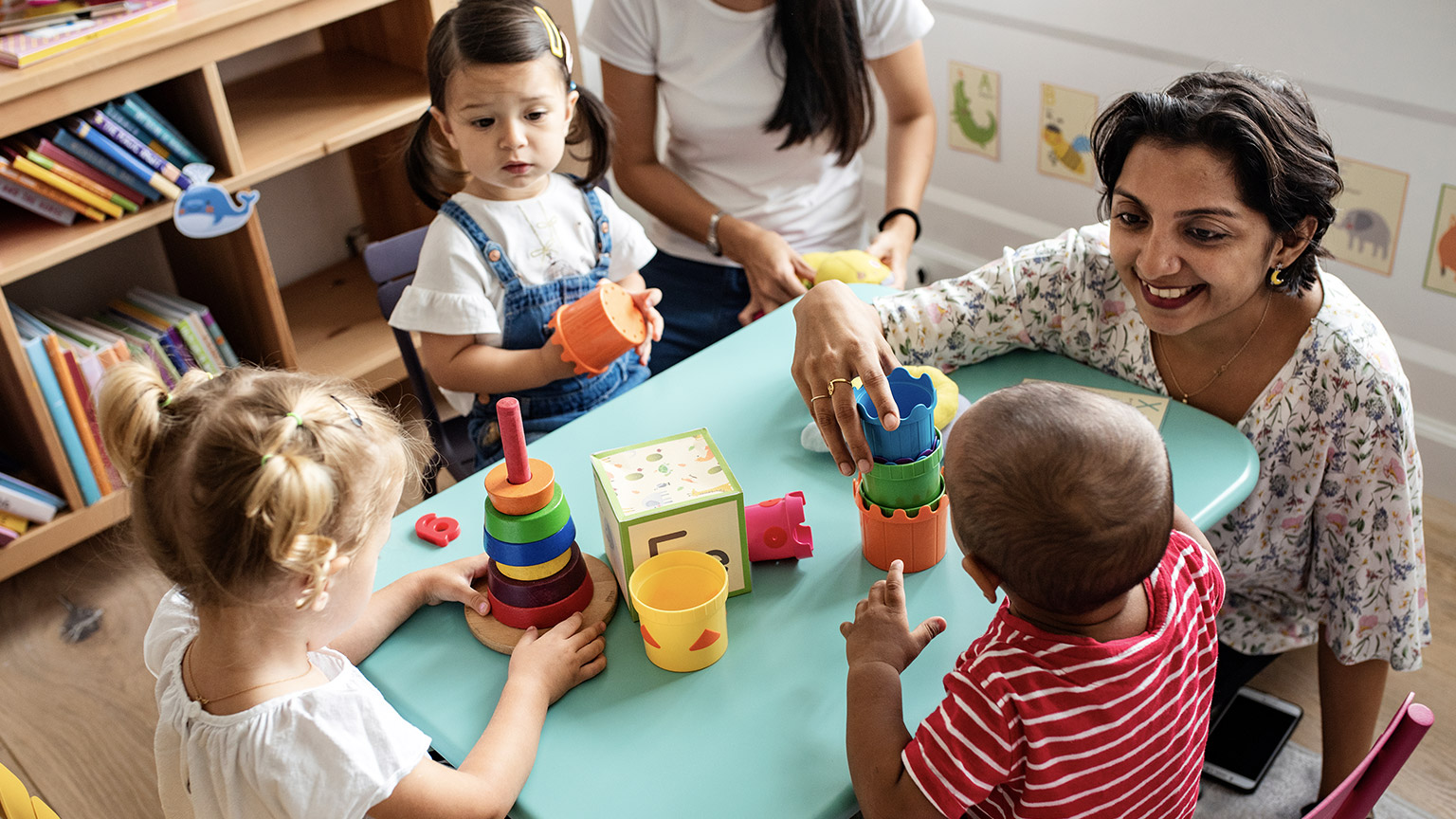 children building blocks with adult