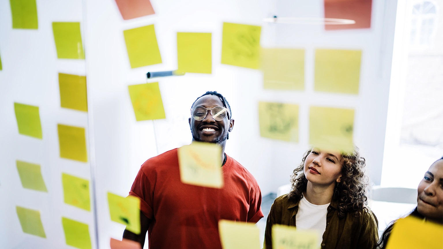 happy team looking at sticky notes