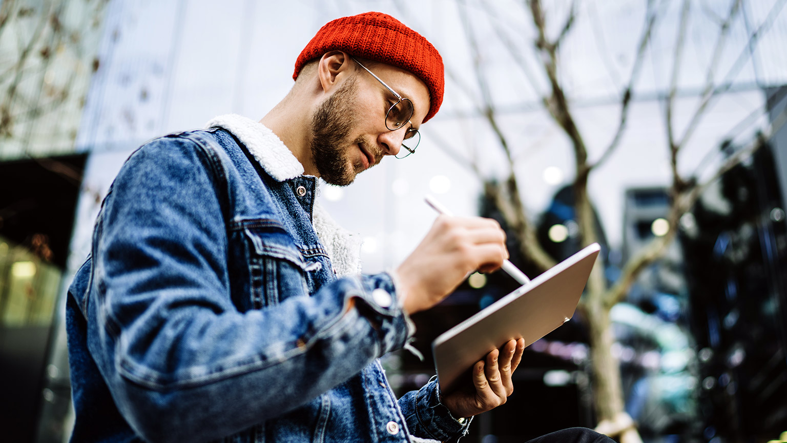 man working on tablet outdoor