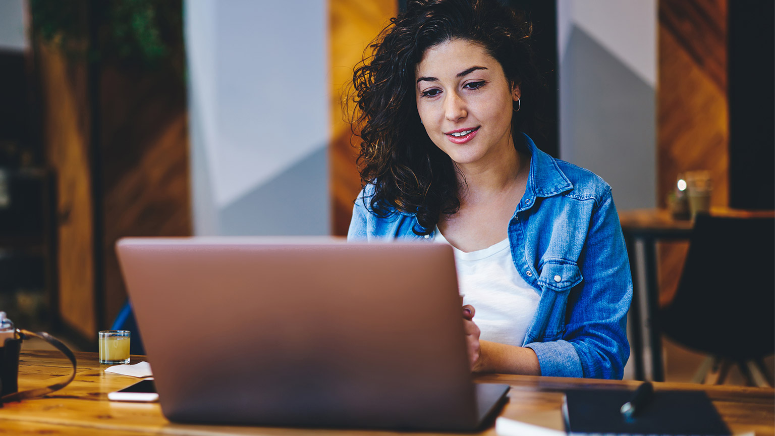 A student reading reference materials on a laptop