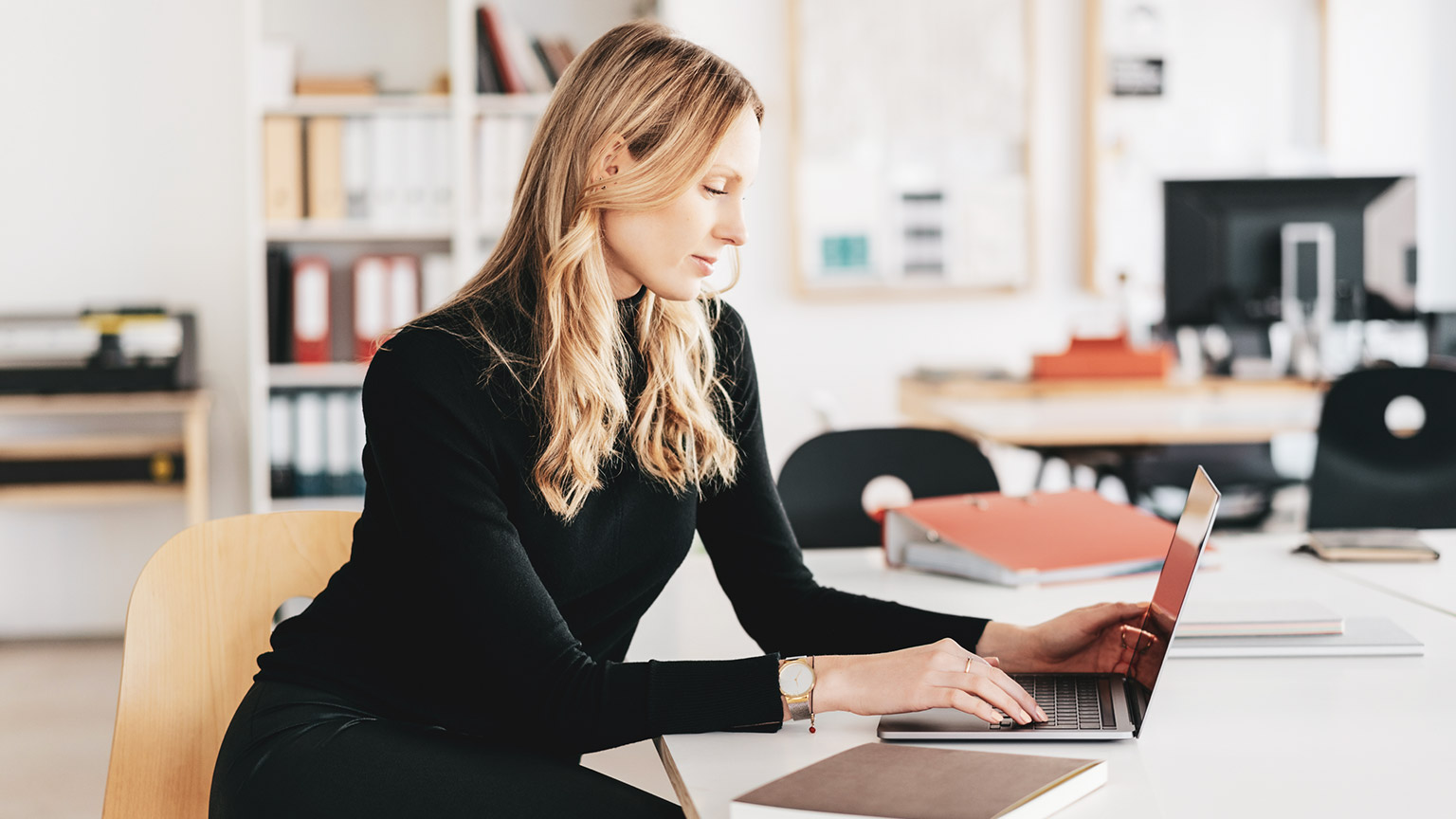 An accountant working on a budget using a laptop