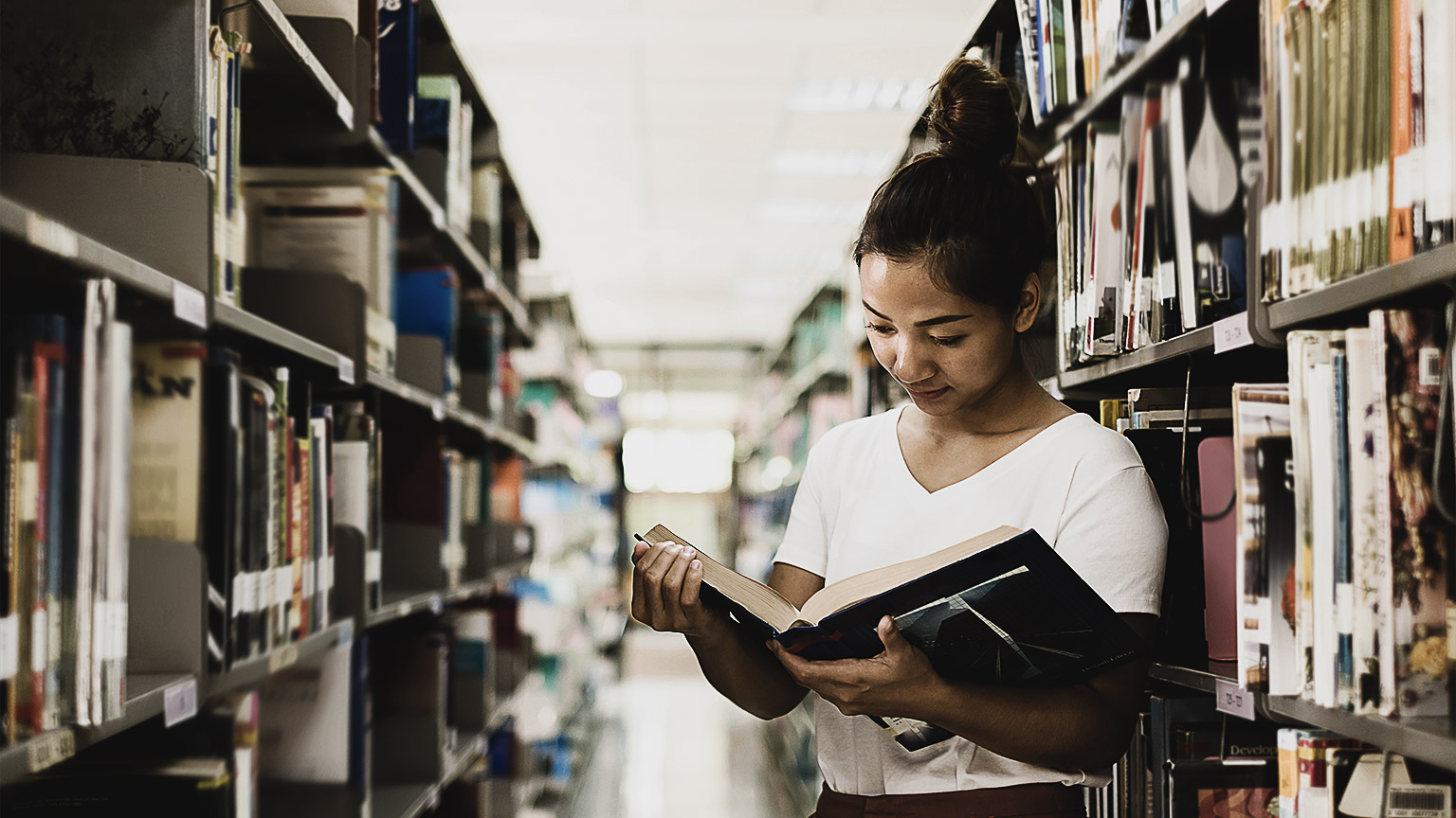 A person reading in a library