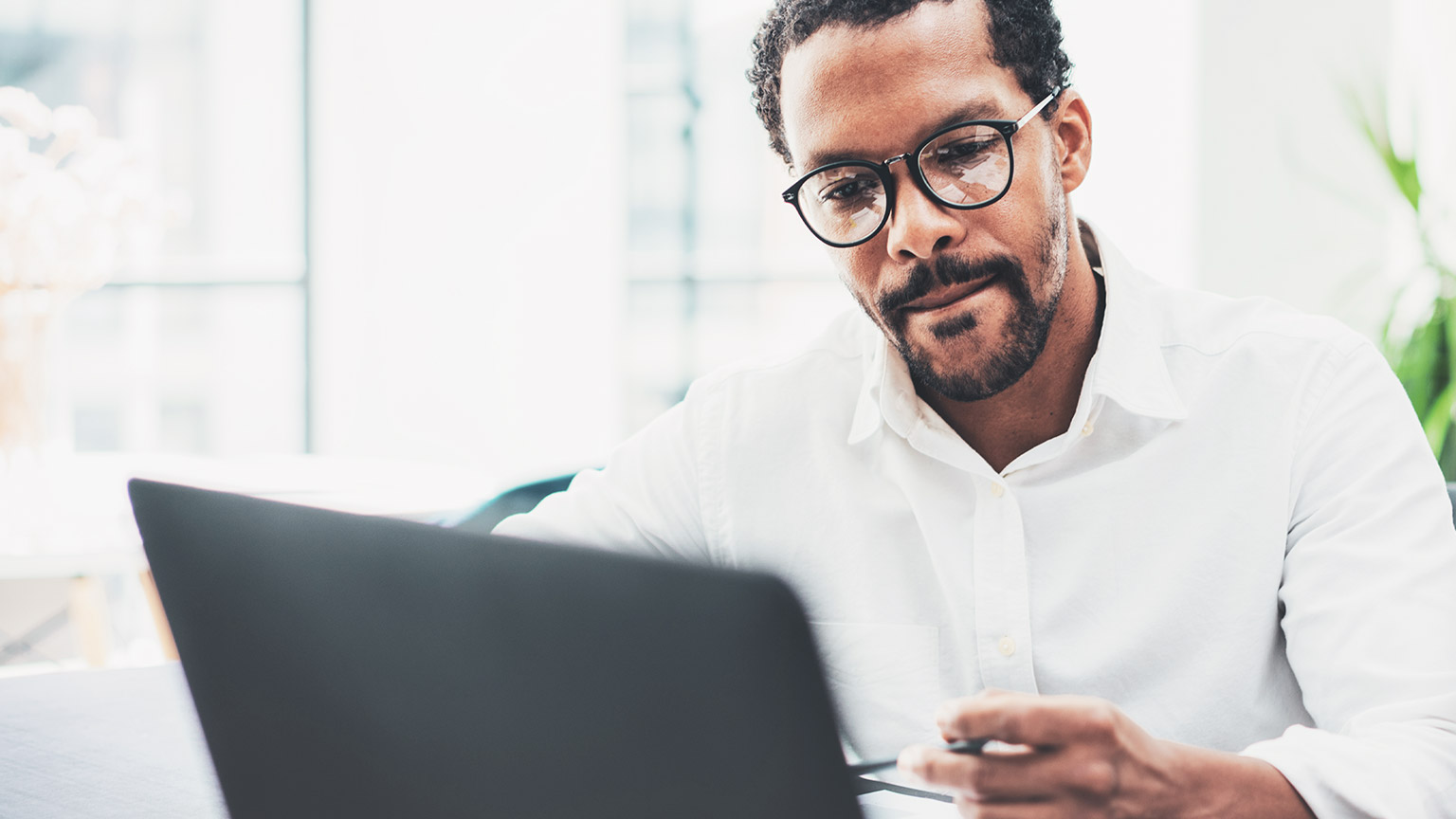 A close view of a business manager working on a budget forecast on a laptop