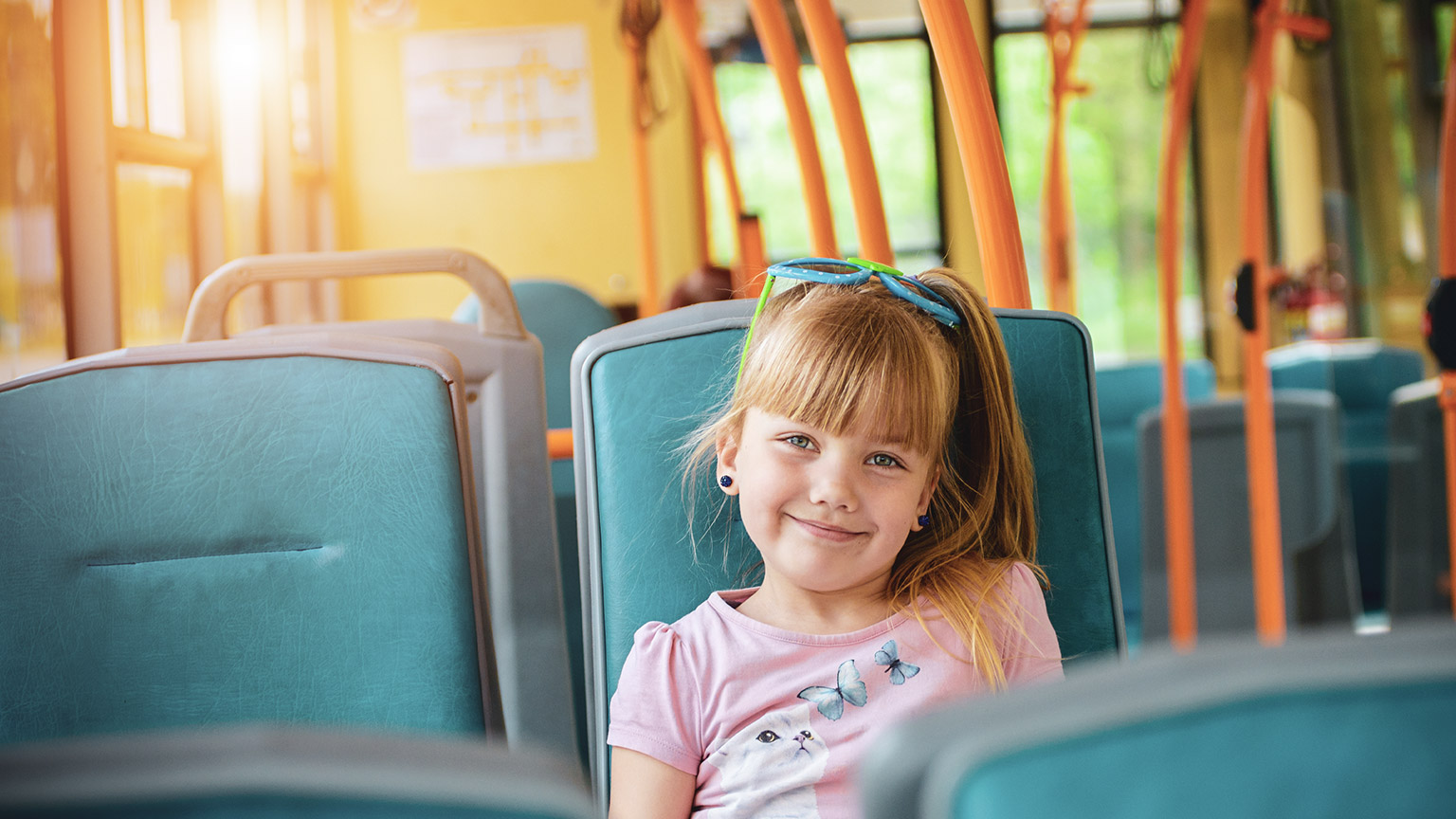 A young child sitting on a bus