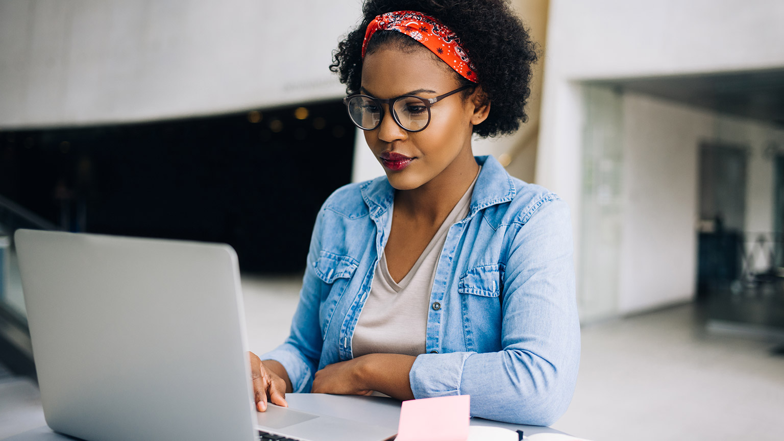 A small business owner working on a budget on a laptop