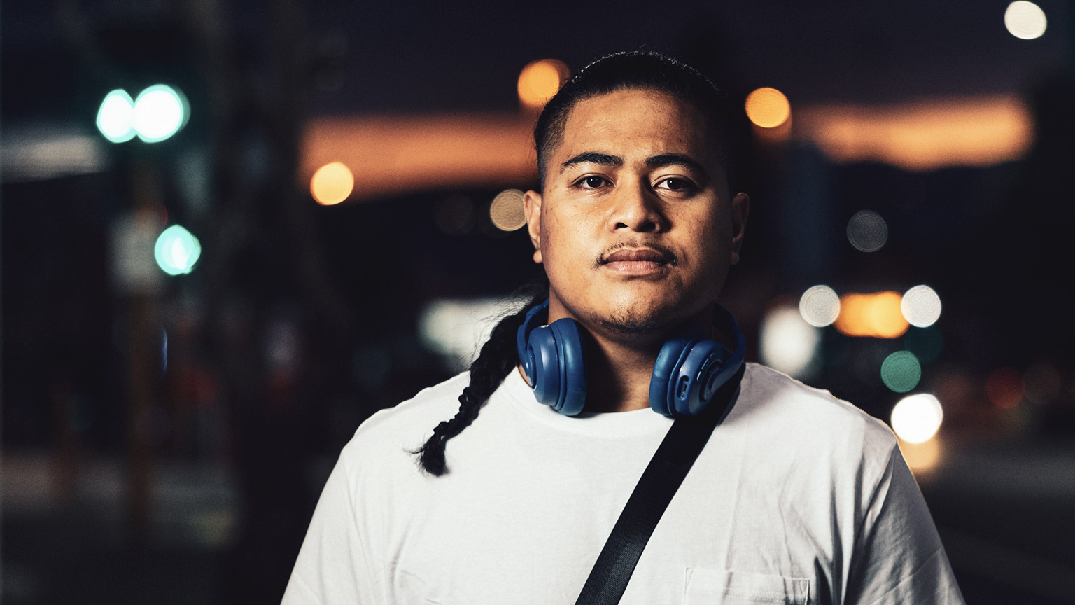 A close view of a young Pasifika male in an outdoor evening setting