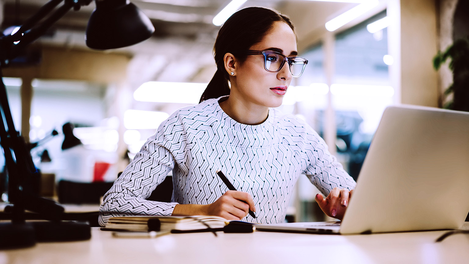 woman writing with computer