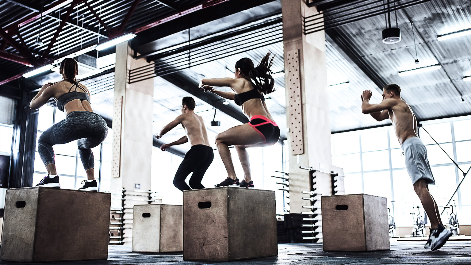 Cross fit training. Jumping on a box together.