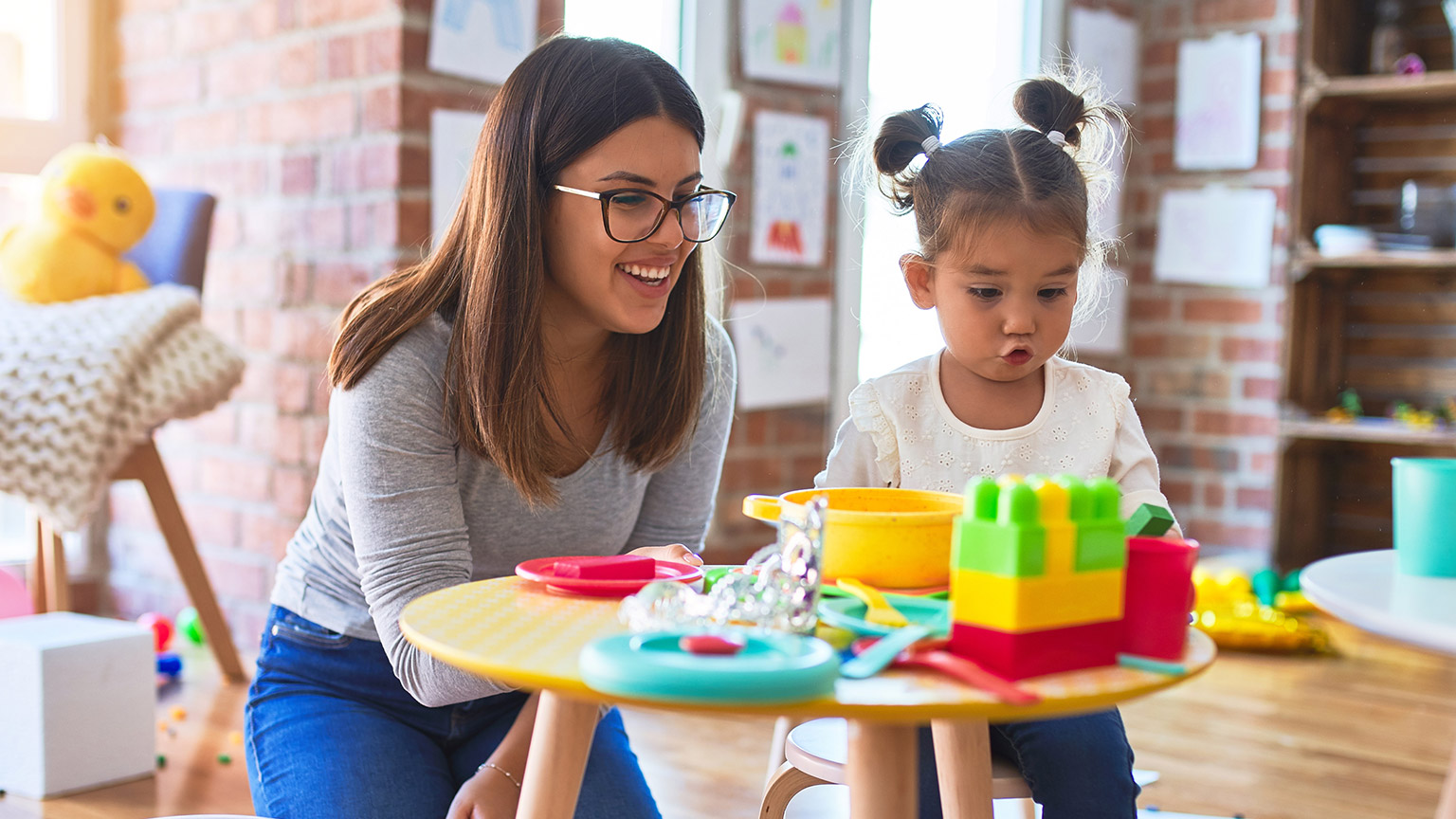 A childcare worker interacting with a child