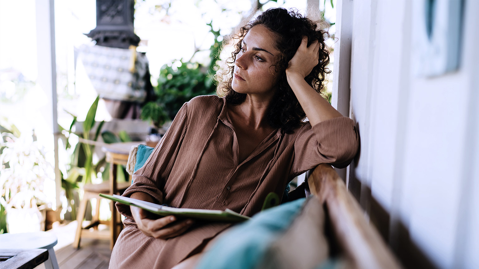 Contemplative woman with notebook