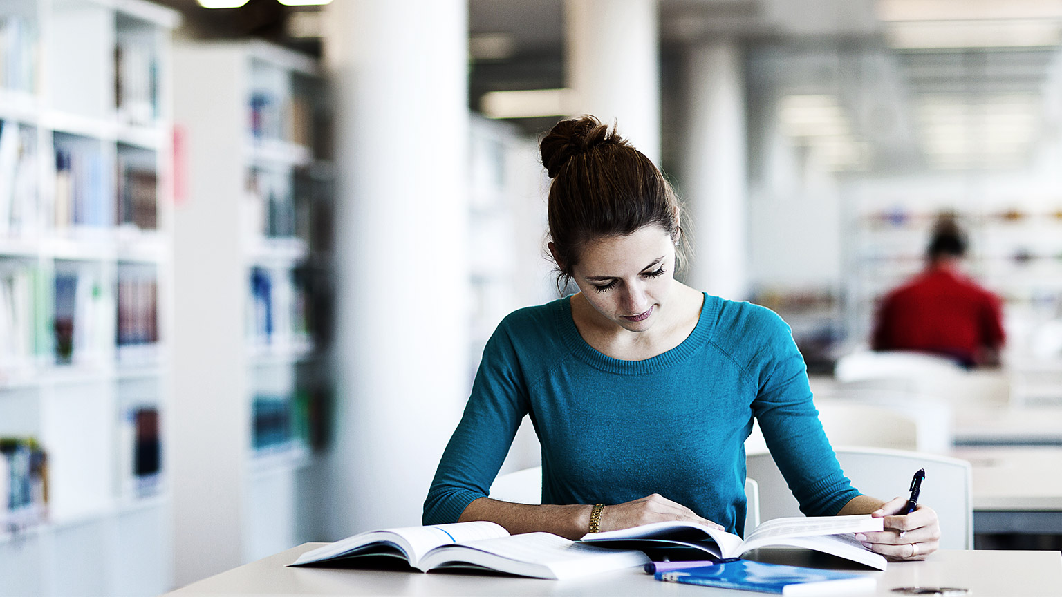 A person reading and learning in a library