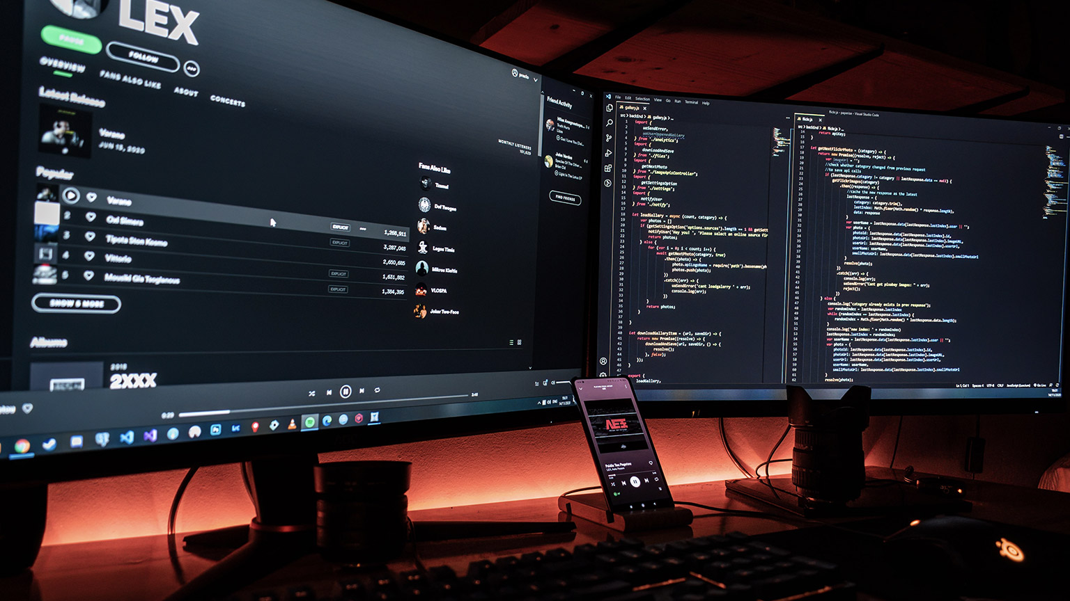 A wide shot of a developer's desk with multiple devices in use