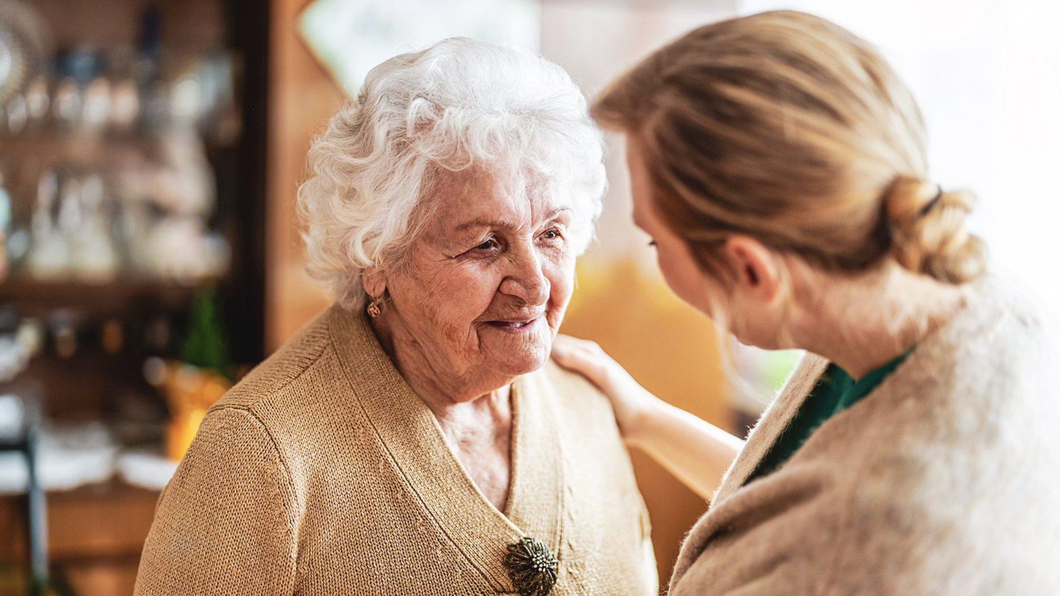 A worker talking with an elderly client