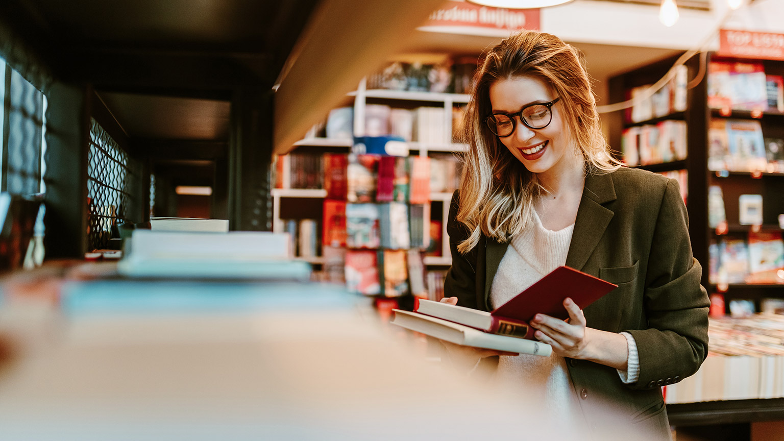 A student reading reference materials in a library