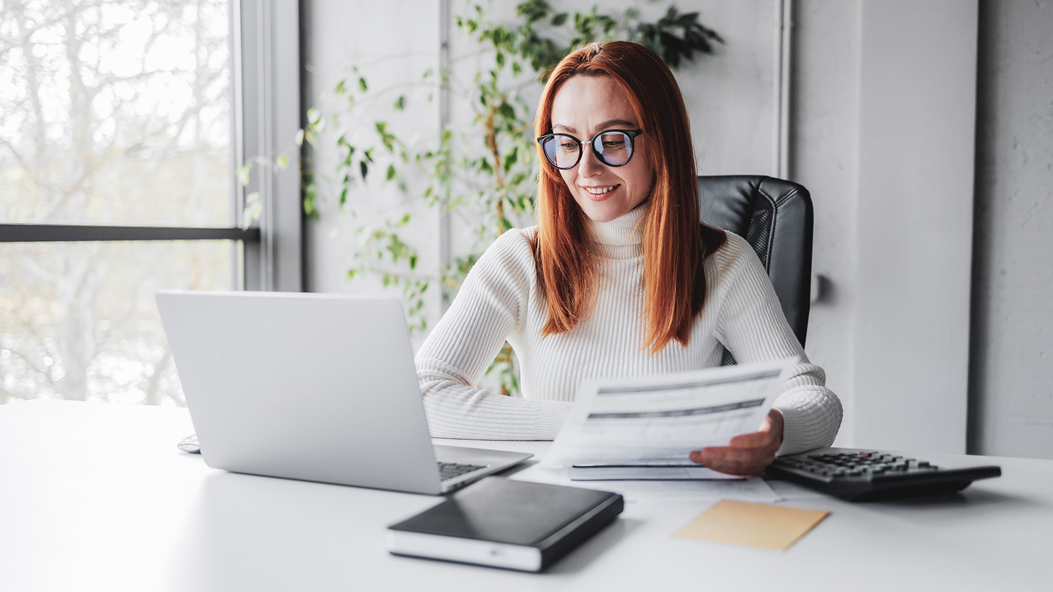 An accountant smiling while crunching numbers