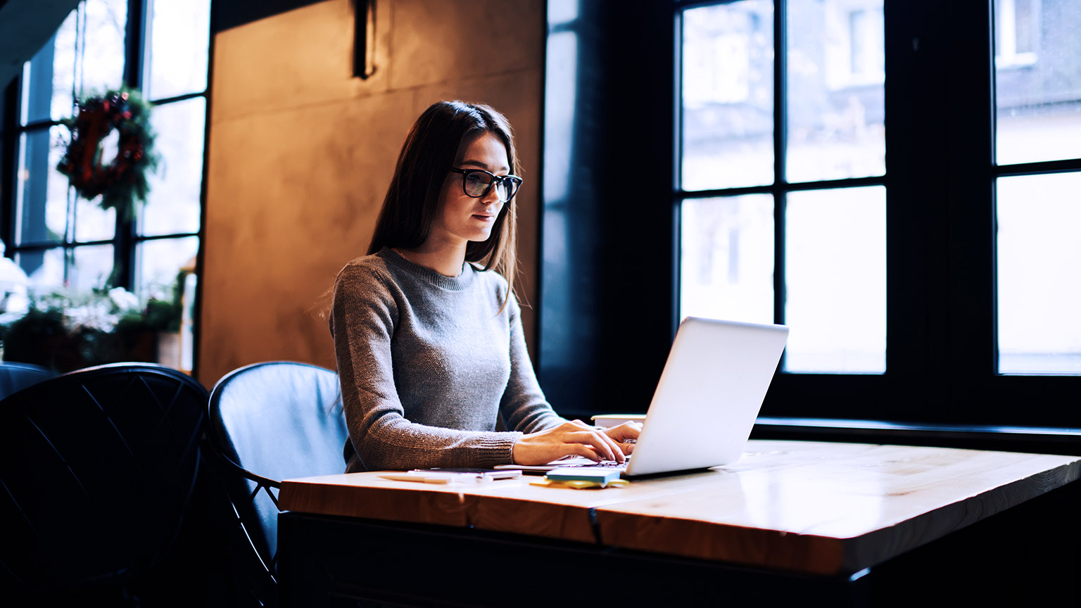 Woman with eyeglass working on computer