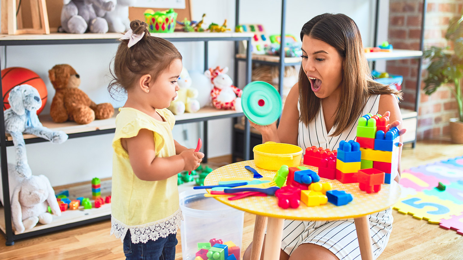 A childcare worker interacting with a child