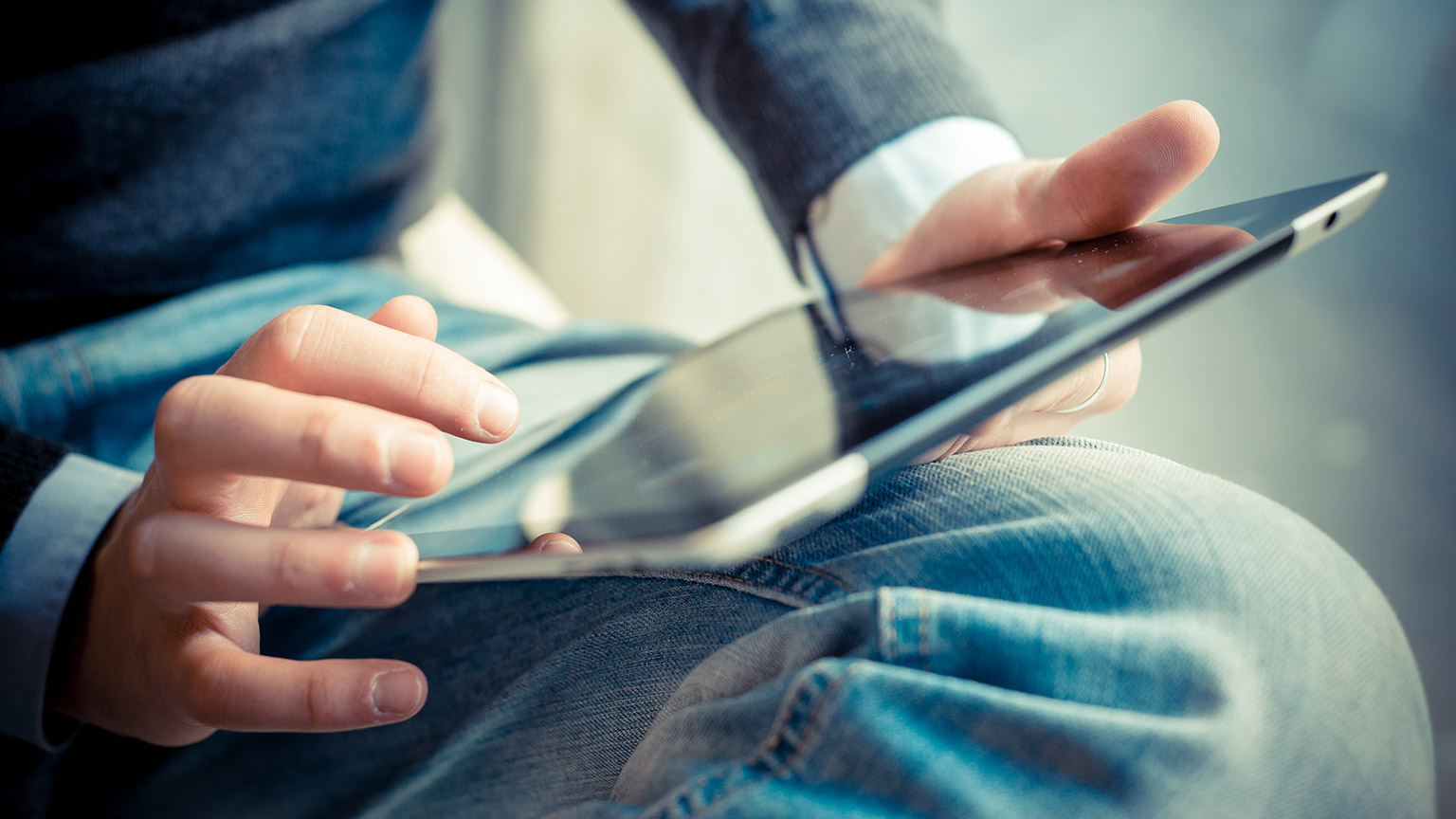 A close view of a person accessing resources on a tablet device