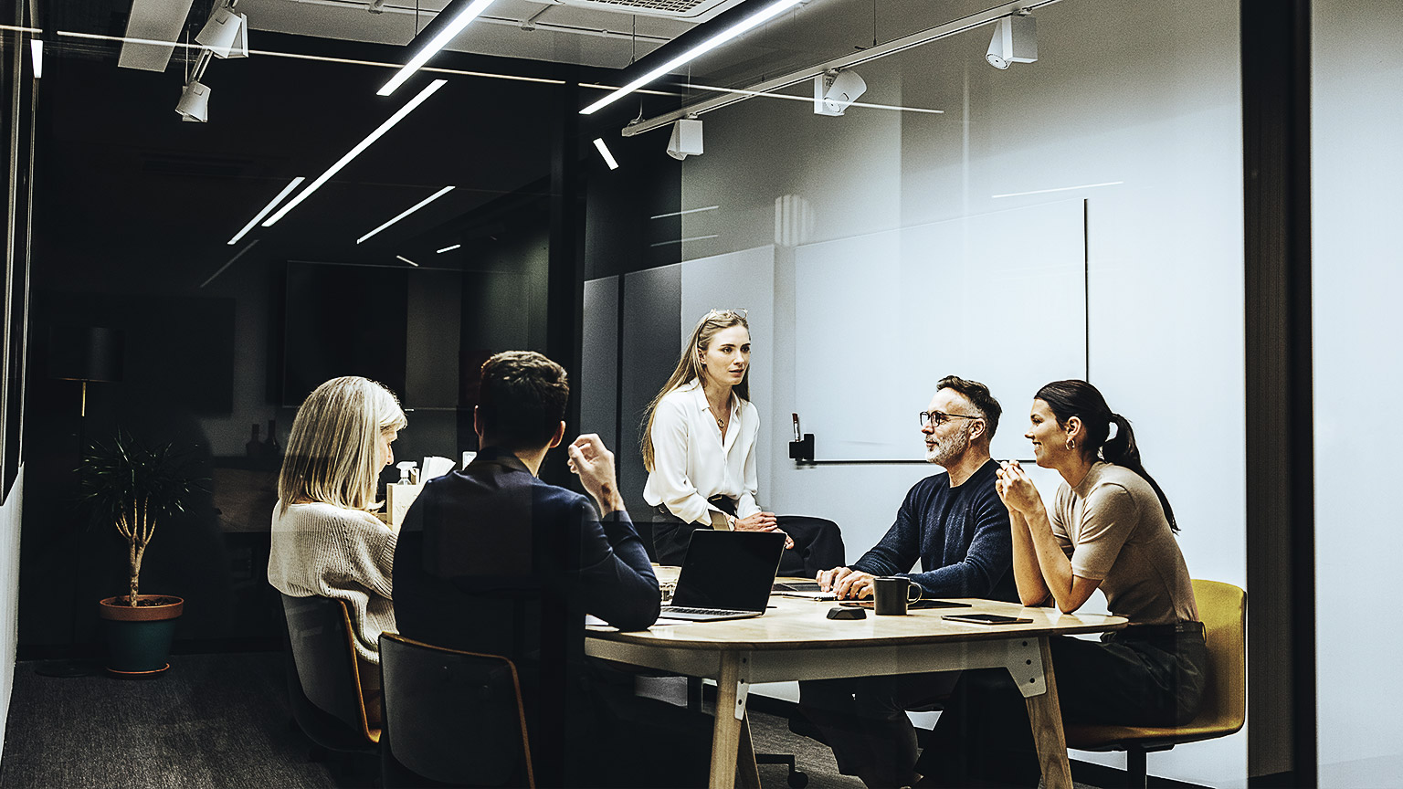 A young professional in a meeting with several colleagues