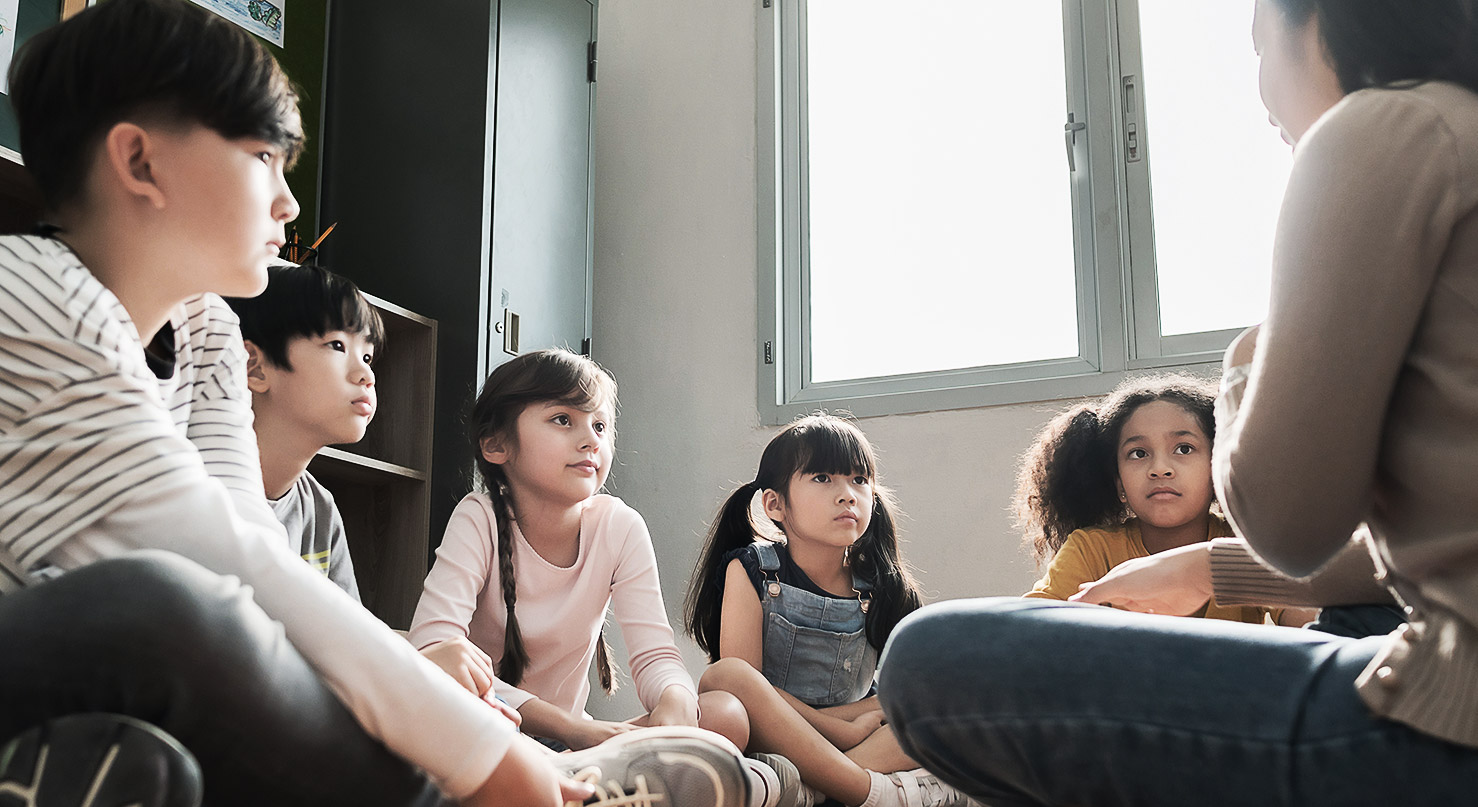 A group of children having a serious talk with teacher