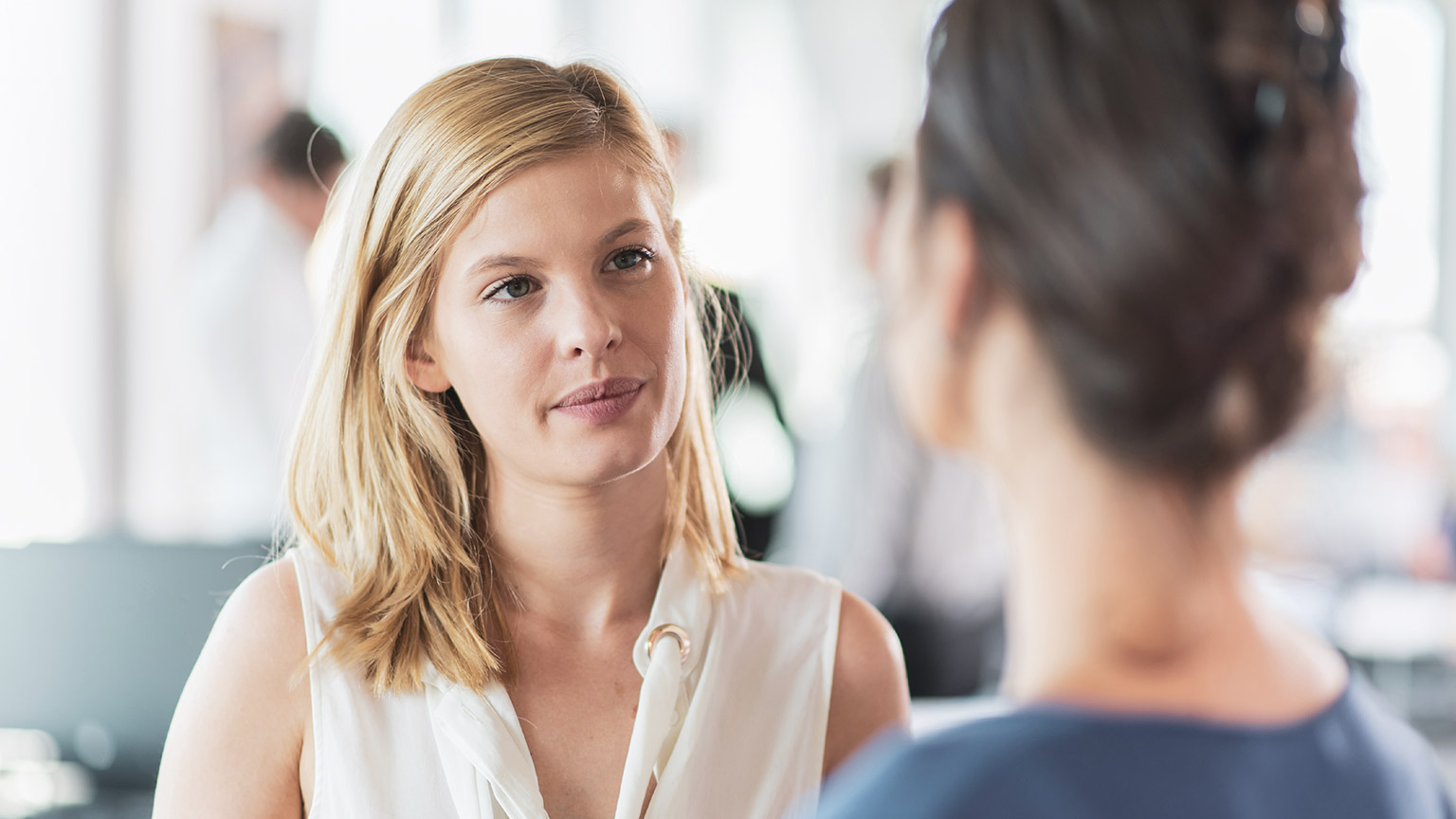 A supervisor listening to a complaint from a parent