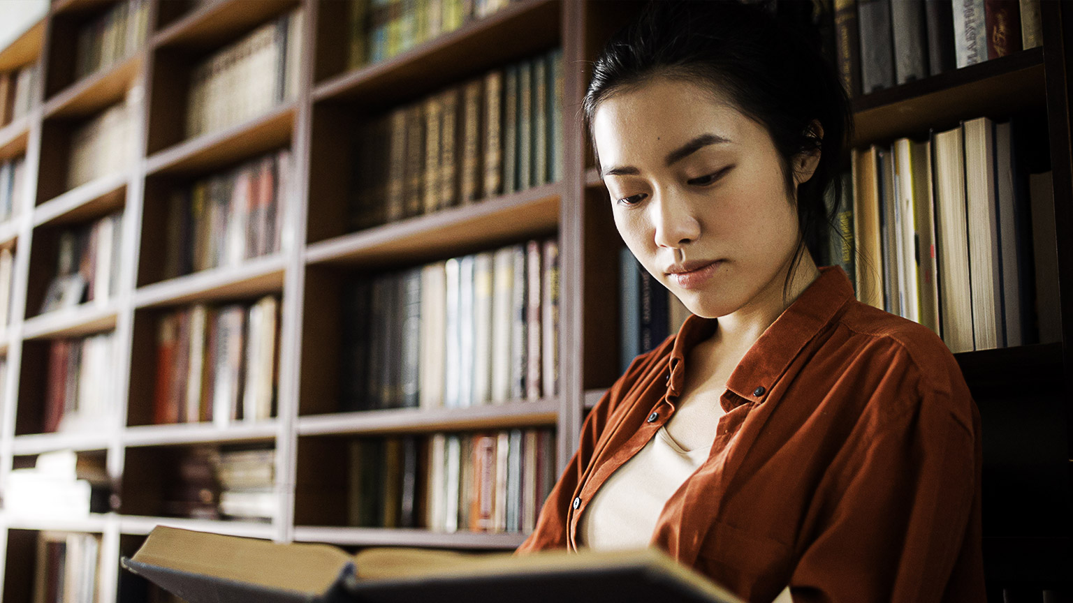 A person researching in a library