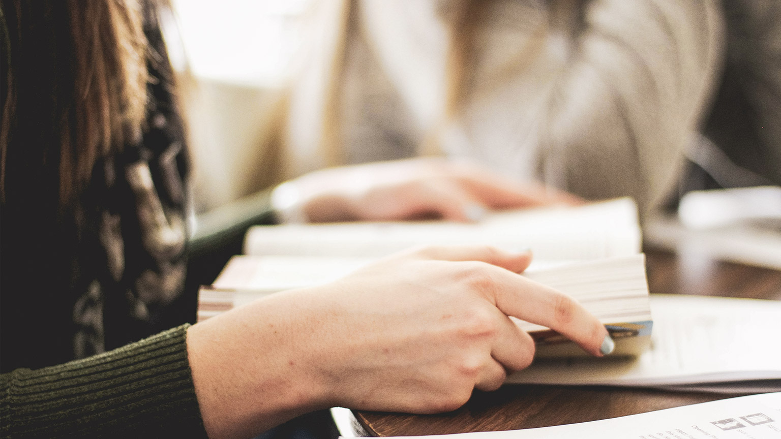 A close view of a person reading a book