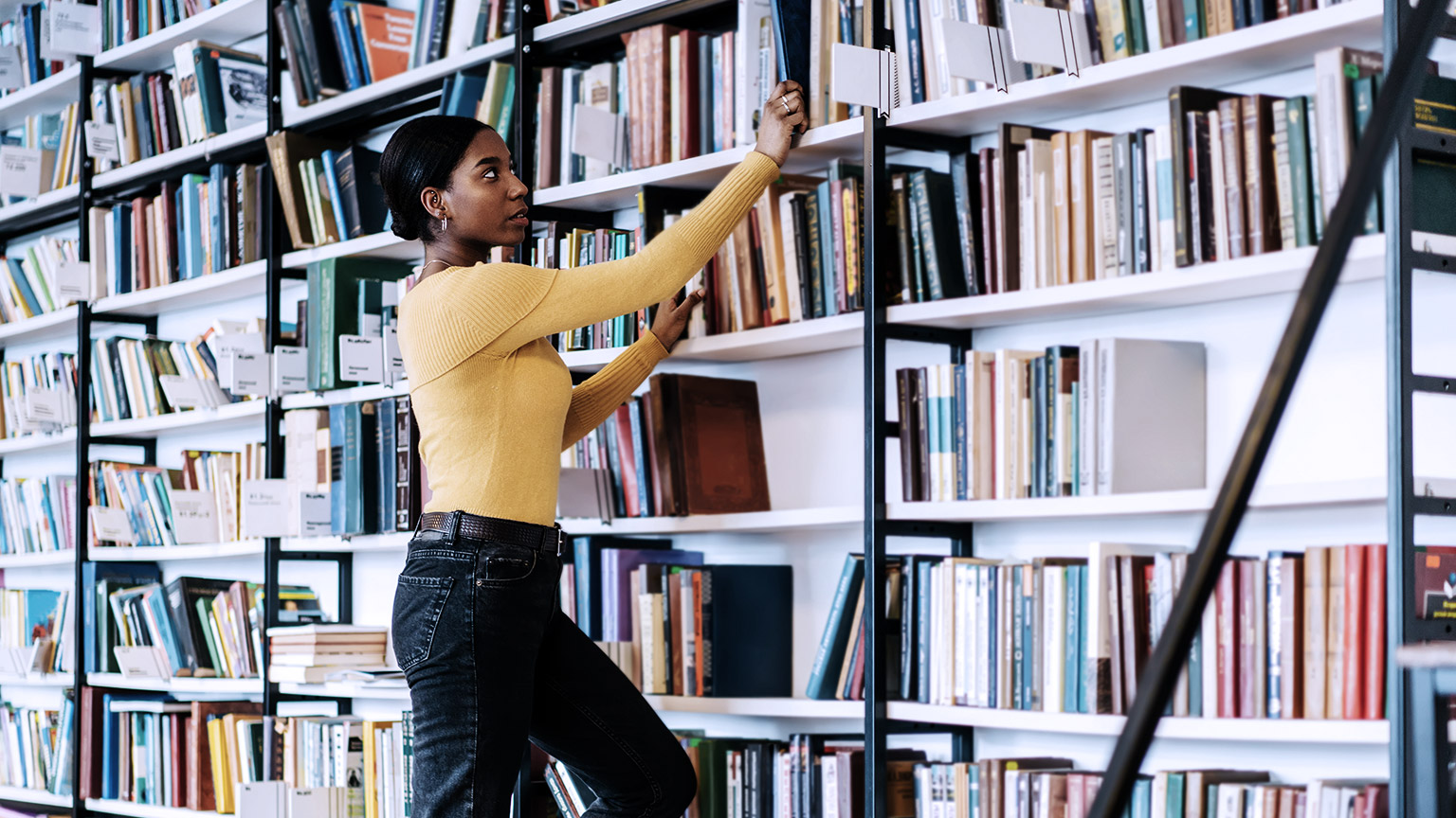 Female browsing books in the library