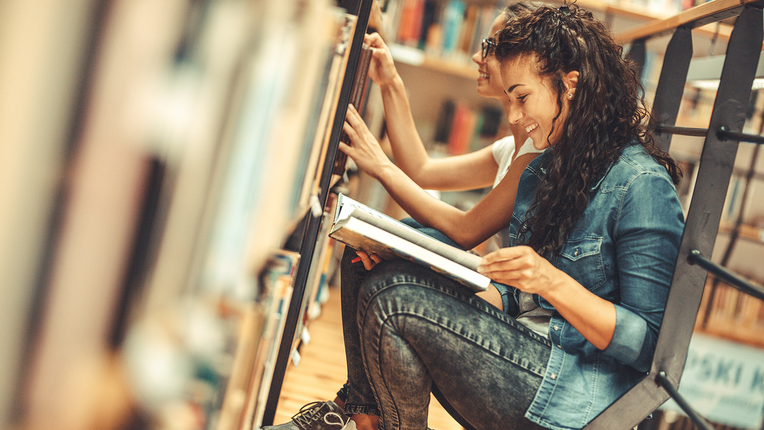 A student reading materials in a library