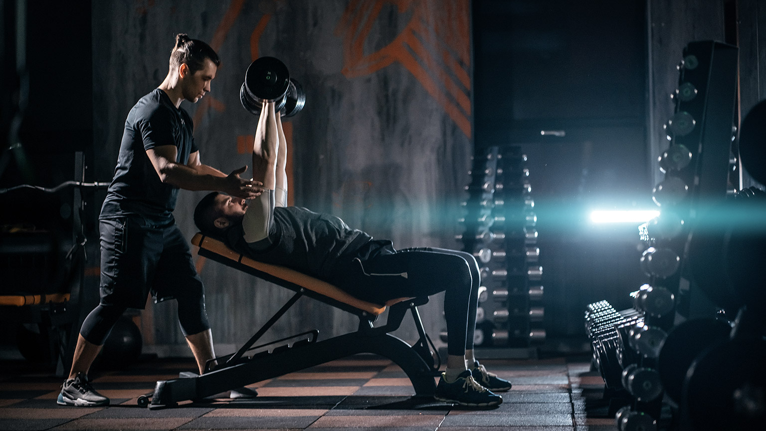 Man working out with physical trainer