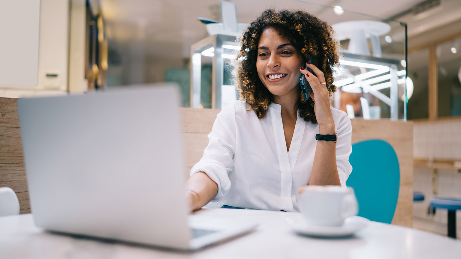 An accoutant talking to a client on a phone while sitting in an office