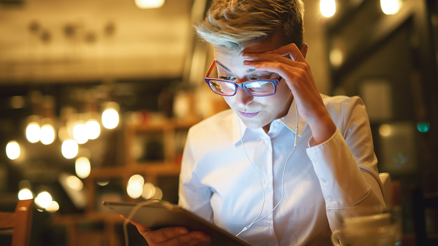 A person reading business reference materials on a tablet device