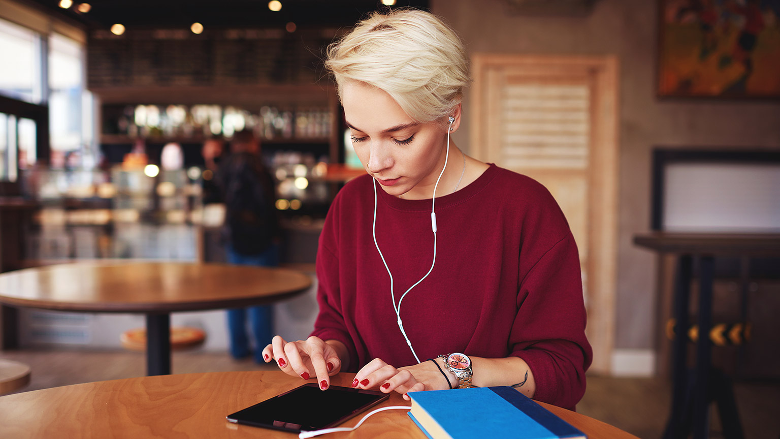 A person reading reference materials on a tablet device