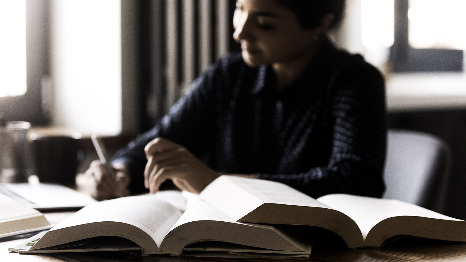 A person reading multiple books