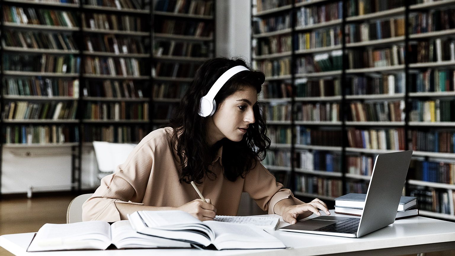 A pharmacy student studying in a library