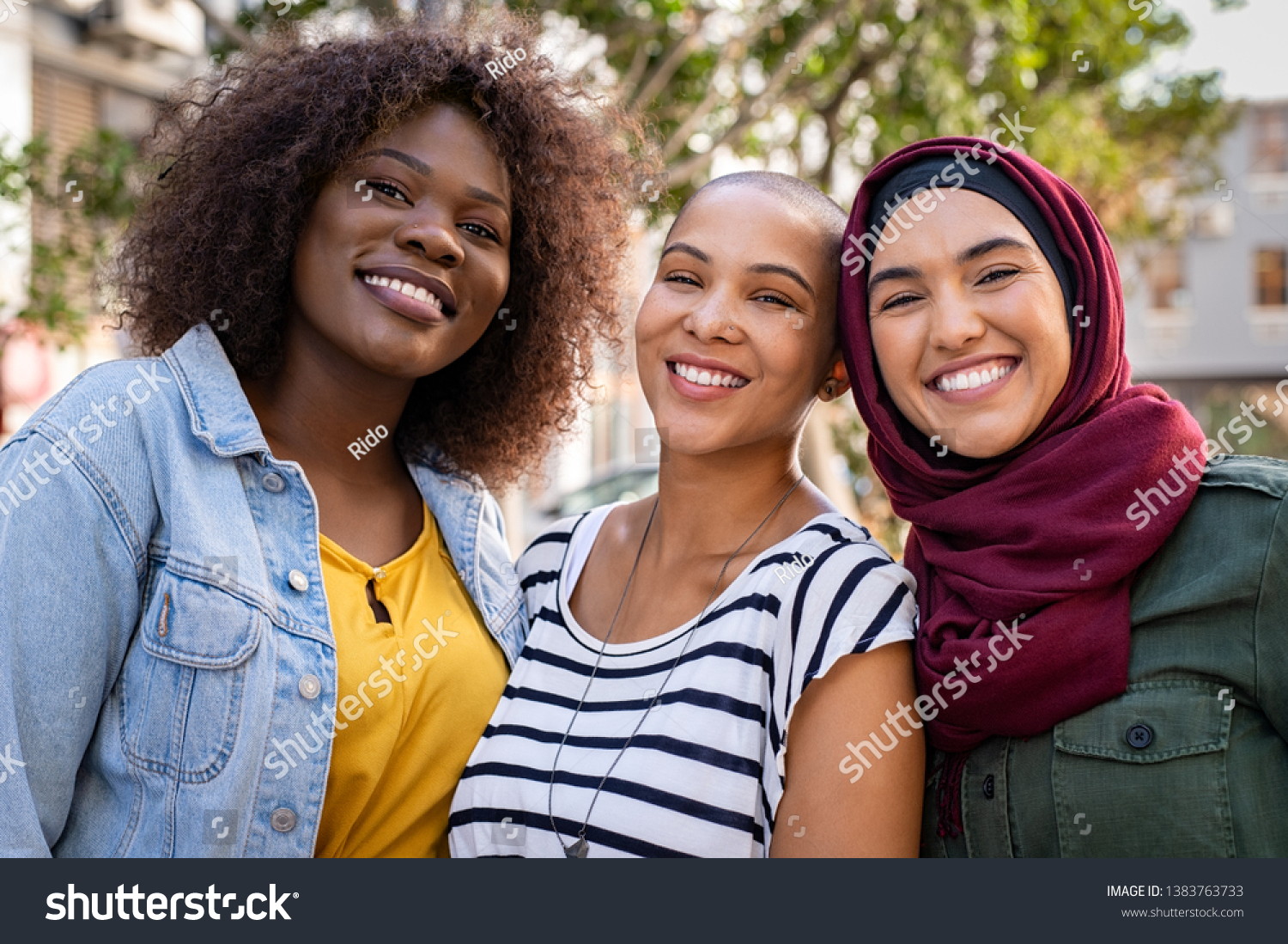 stock-photo-group-of-three-happy-multiethnic-friends-looking-at-camera-portrait-of-young-women-of-different-1383763733