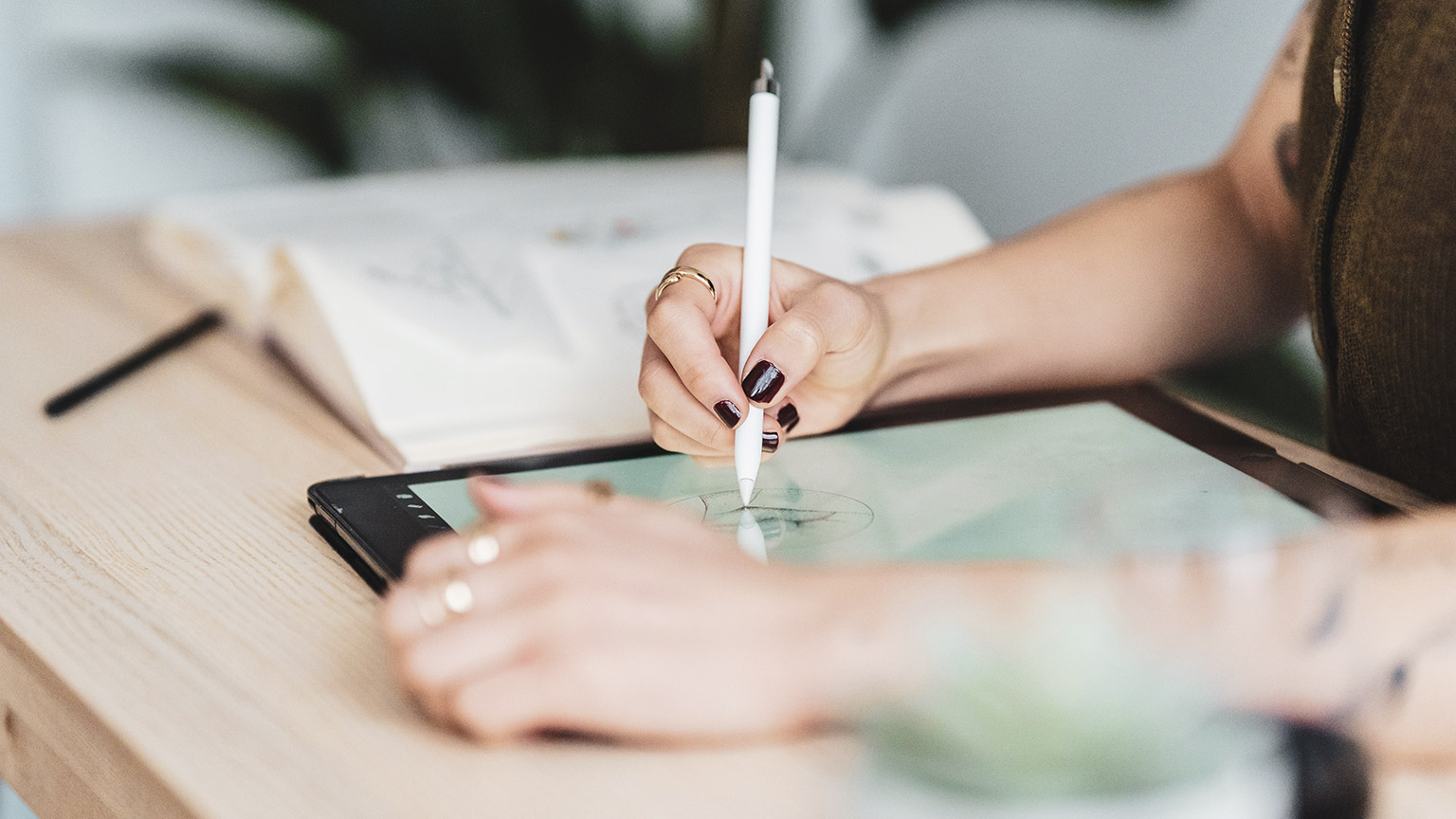 An illustrator working on a digital tablet